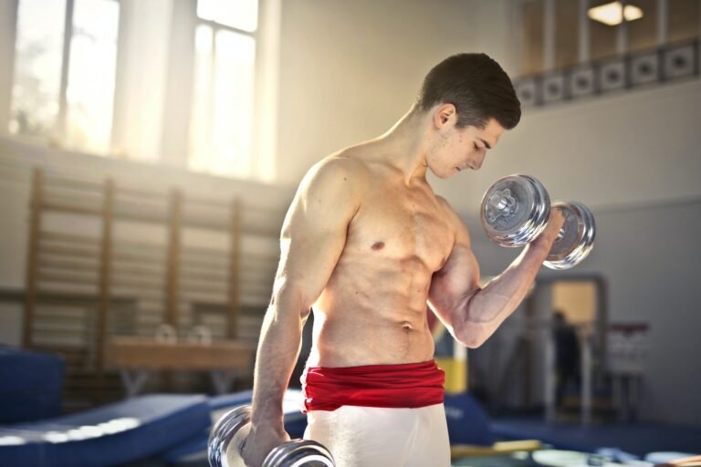 Topless Man Lifting a Silver Dumbbells