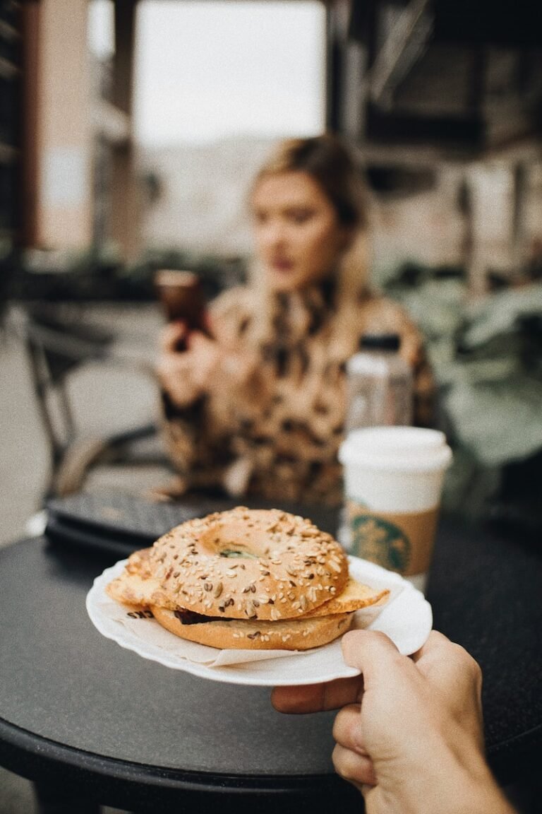 a person sitting at a table with a plate of food