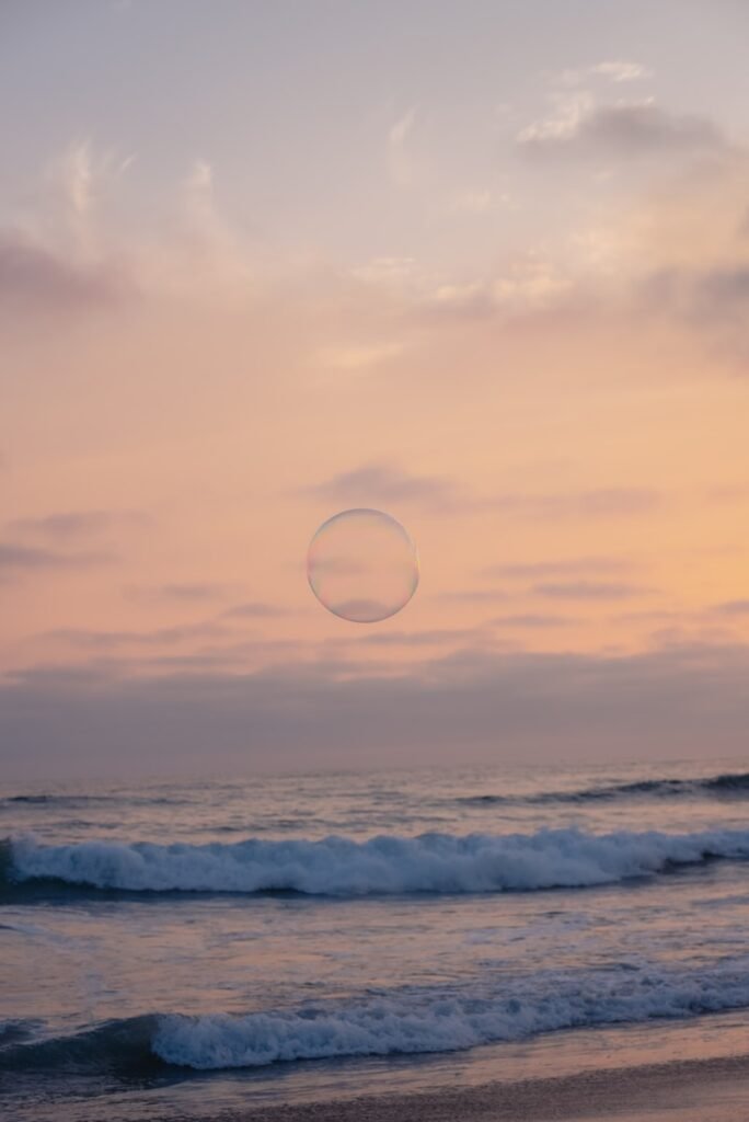 a person standing on a beach flying a kite