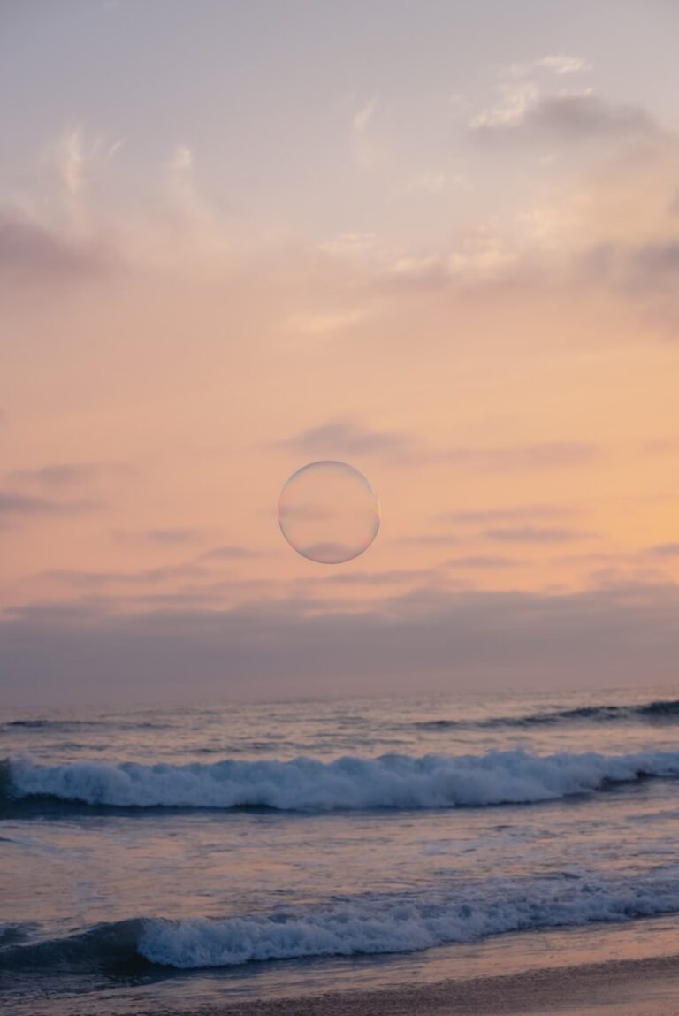 a person standing on a beach flying a kite